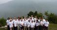 Image 8: The trek team with the backdrop of the Annapurnas