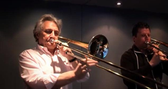 John Suchet playing the trombone