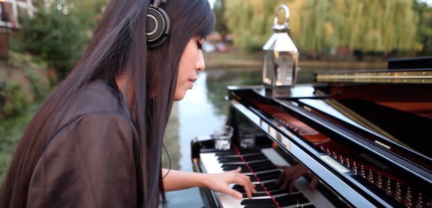 HJ Lim plays piano on a river