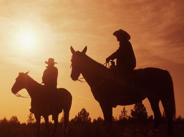 cowboys at sunset