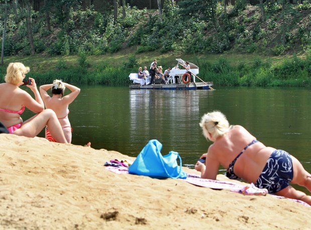 Petras Geniusas performs on a river