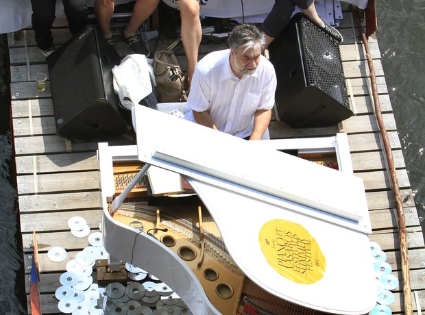 Petras Geniusas performs on a river