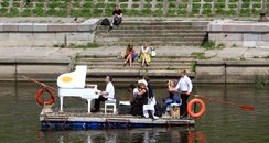 Petras Geniusas performs on a river