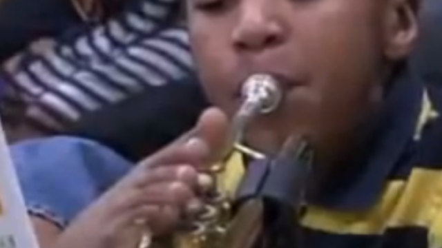 boy with no arms plays trumpet