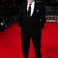 Image 6: Steve McQueen on the BAFTAs red carpet 2014
