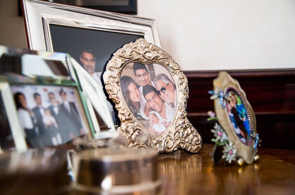 Andrea and his family in his house sitting by his piano. He has two sons  and one daughter, as you can see on the wall he has…