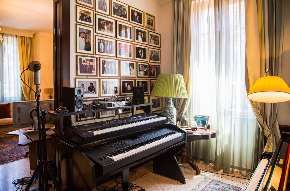 Andrea and his family in his house sitting by his piano. He has two sons  and one daughter, as you can see on the wall he has…