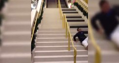 man falls down piano stairs