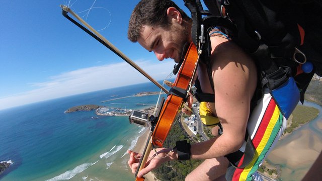 Naked skydiving musician plays violin during jump 