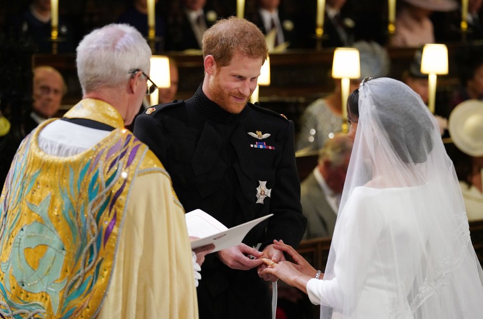 Prince Harry places the wedding ring on the finger